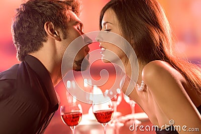 Young couple kissing in restaurant