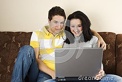 Young couple with laptop home