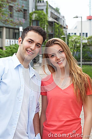 Young couple laughing at camera