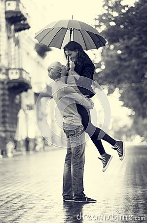 Young couple on the street of the city with umbrella