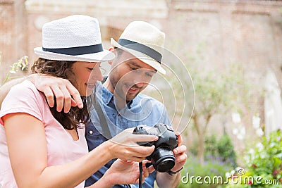 Young couple of tourist watching photographs