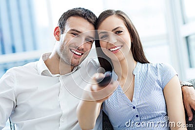 Young couple with TV remote