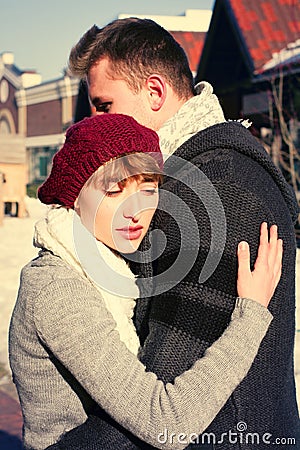 Young couple walking around city in winter.