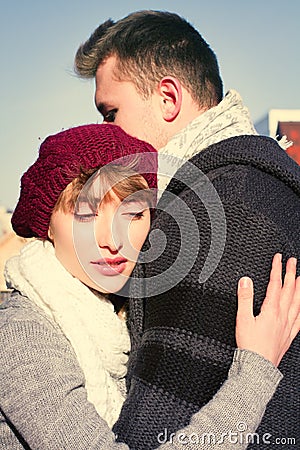Young couple walking around city in winter.