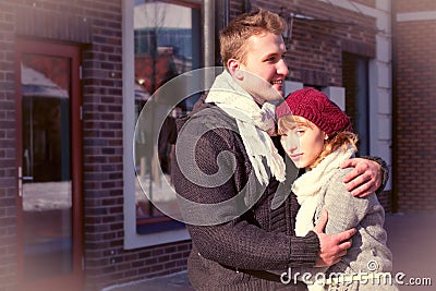 Young couple walking around city in winter.