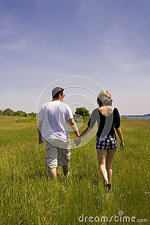Young Couple Walking in Field