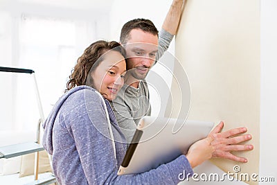 Young couple watching plans in their new flat