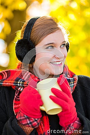 Young cute woman / girl drinking hot chocolate / cocoa/ tea in t