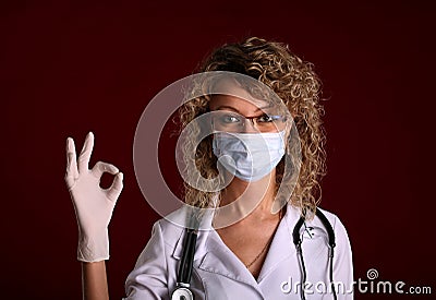 Young doctor woman with stethoscope shows ok