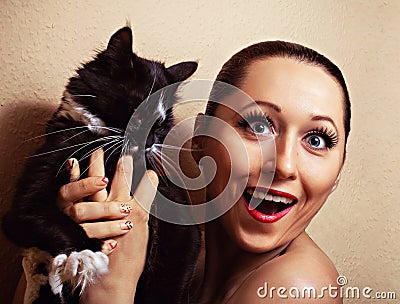 Young emotional woman with pet cat