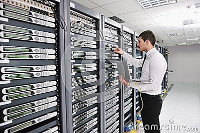 Young engeneer in datacenter server room