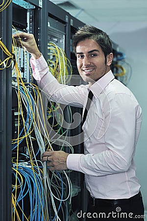 Young it engineer in datacenter server room