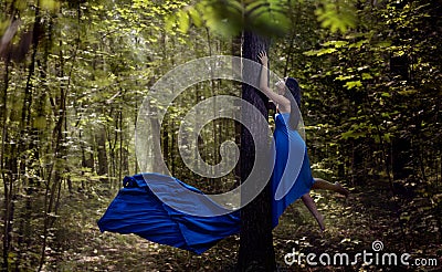 Young fairy woman flying up in forest