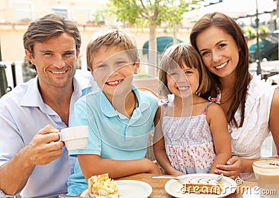 Young Family Enjoying Cup Of Coffee