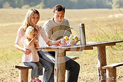 Young family having a picnic in nature