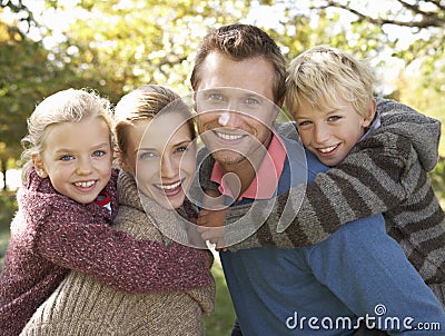 Young family pose in park