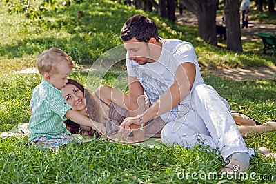 Young family relaxing in park
