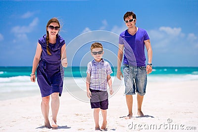 Young family walking along beach