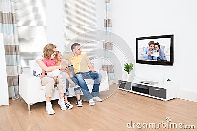 Young family watching tv together