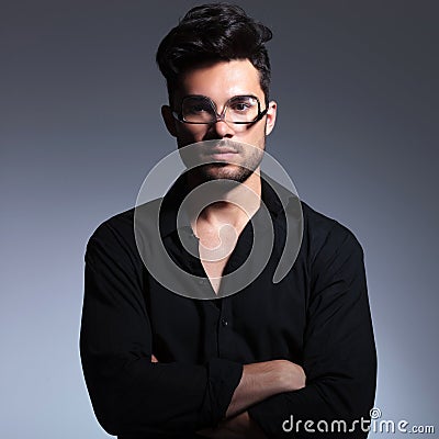 Young fashion man holds glasses upside down