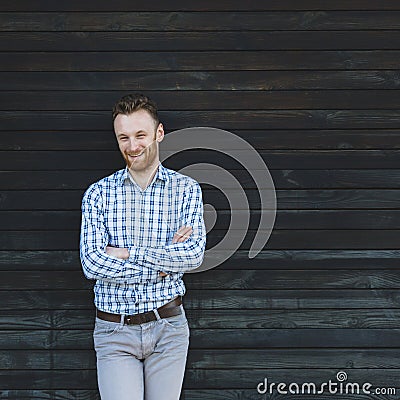 Young fashionable man against wooden wall