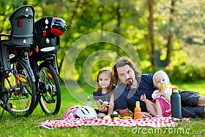 Young father and his daughters having a picnic