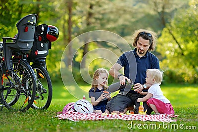 Young father and his daughters having a picnic