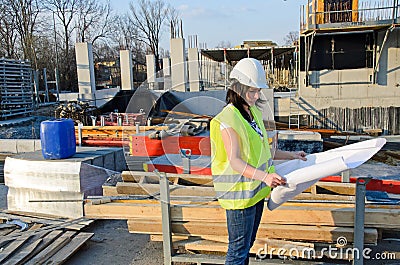 Young female architect at the construction site of the construction project