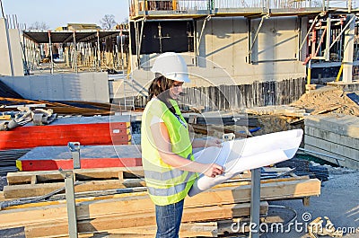 Young female architect at the construction site of the construction project