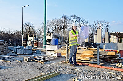 Young female architect at the construction site of the construction project
