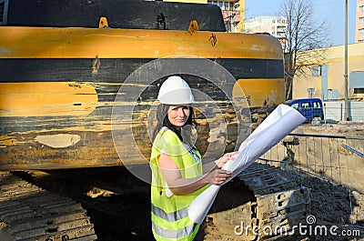 Young female architect at the construction site of the construction project