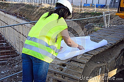 Young female architect at the construction site of the construction project