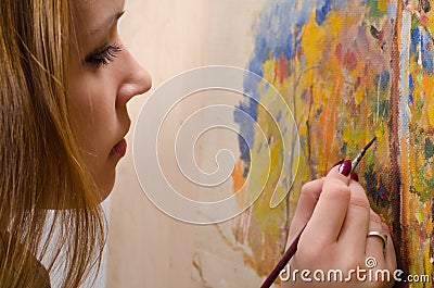 Young female artist painting landscape
