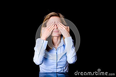 Young female covers her eyes, fear or surprise