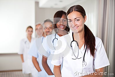 Young female doctor with group of colleagues