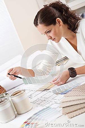 Young female interior designer working at office