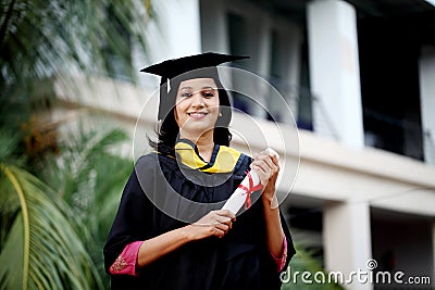 Young female student with diploma at outdoors