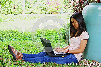 Young female student with a laptop computer in th