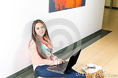 Young female student using laptop