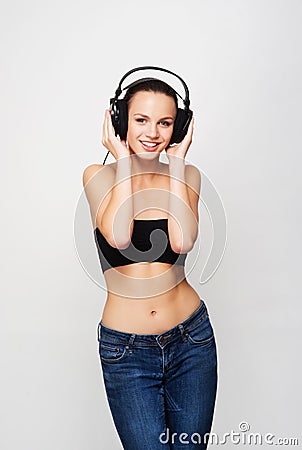 A young and fit teenage girl listening to music in headphones