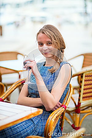 Young French woman drinking red wine