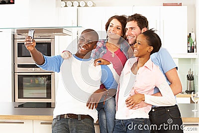 Young Friends Taking Photo In Kitchen