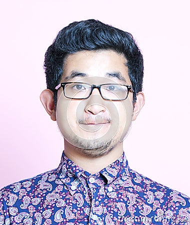 Young Geeky Asian Man in colorful shirt wearing glasses