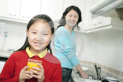 Young Girl Holding Glass of Orange Juice