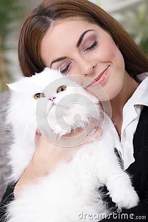 Young girl hugging a white Persian cat