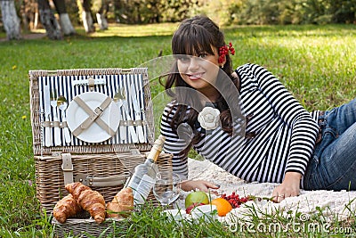 Young girl with picnic basket in the park