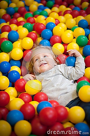 Young girl playing in a ball pool