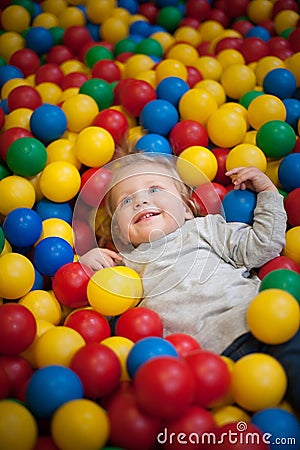 Young girl playing in a ball pool