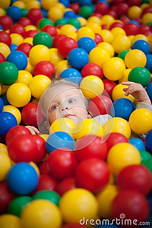 Young girl playing in a ball pool