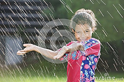 Young girl playing in the rain